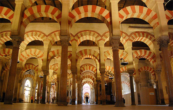 Red and white striped arches inside building