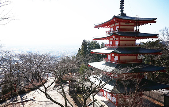 A traditional, red and yellow, multi-tiered Japanese house