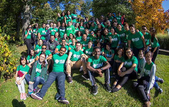 Group of OISS students outside smile at camera