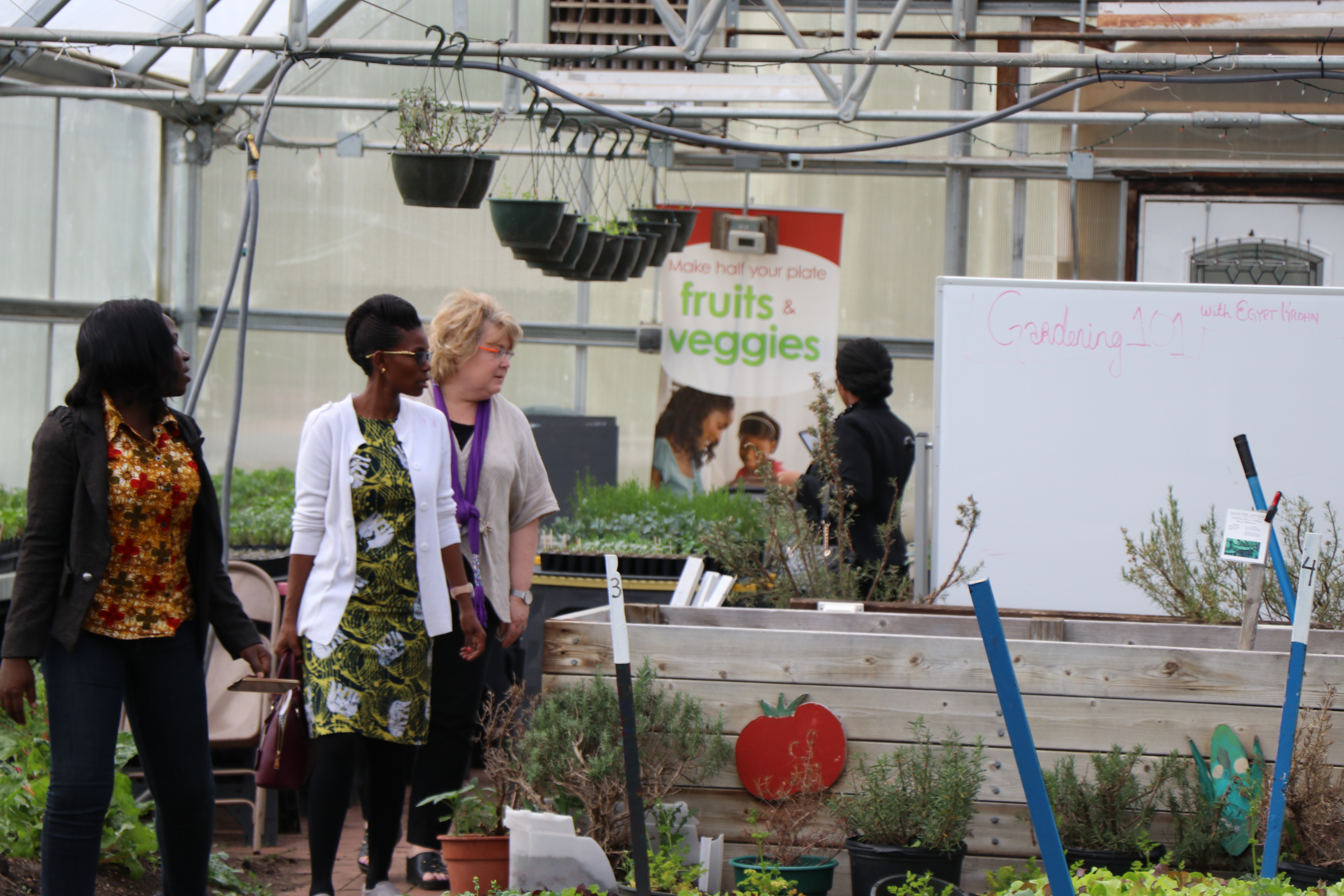 Dorcus Alowo, Christa Muzanila, and faculty member Wynne Wright in Hunter Park GardenHouse