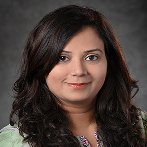 Interior portrait of Raneem Asif in front of blank backdrop